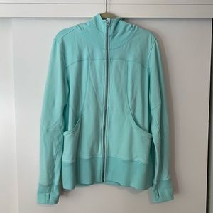 Turquoise athletic jacket.